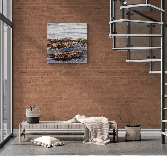 Modern interior with a bed, bench, and painting on a brick wall.