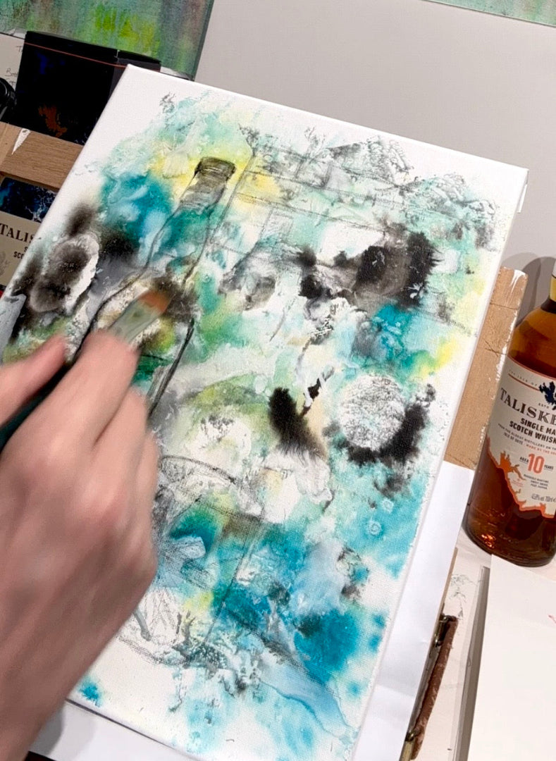 painting process with a bottle of Talisker whisky on a table.